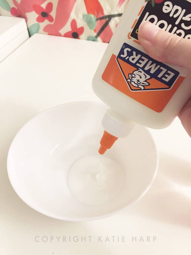 Adding white school glue to a bowl
