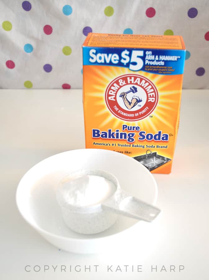 Adding baking soda to a mixing bowl