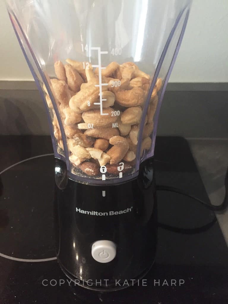 Putting the mixed nuts in a blender
