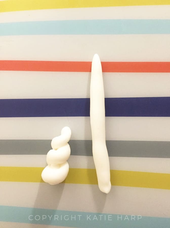 Rolling out white fondant for a unicorn horn