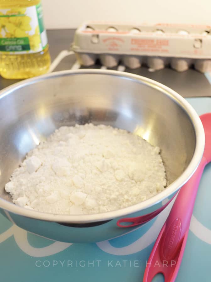 Pouring the boxed cake mix into a large bowl