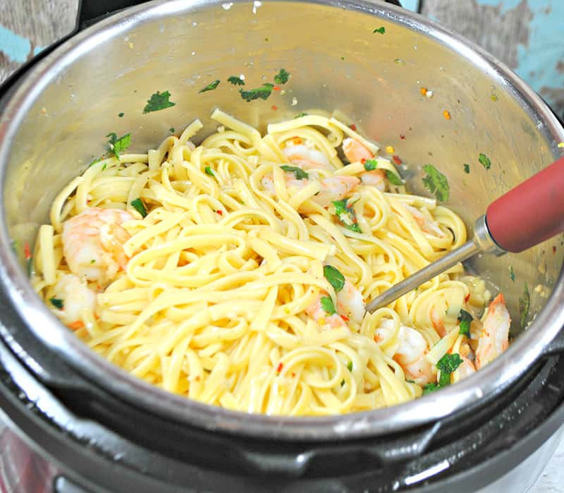 Mixing ingredients with the cooked pasta