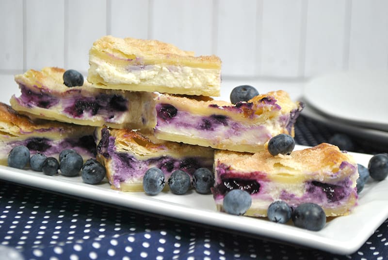 A plate of sopapilla blueberry cheesecake bars