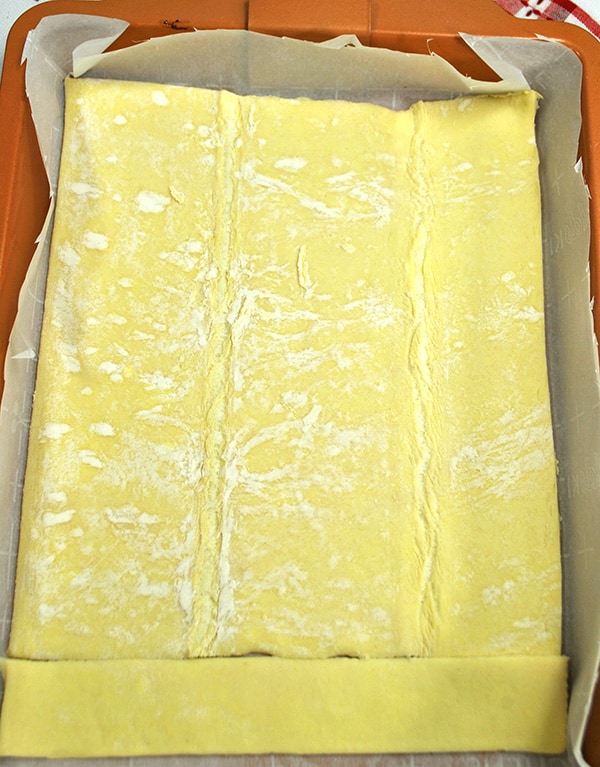 Puff pastry lining the bottom of a baking dish