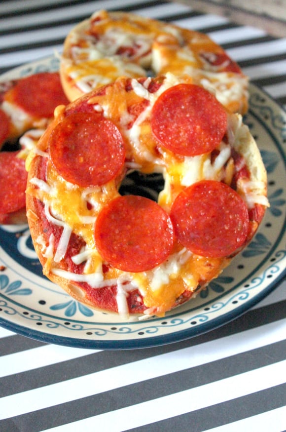 Plating up the finished homemade bagel pizzas