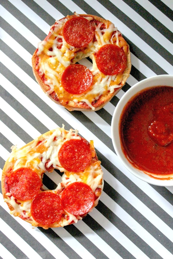 Serving the bagel pizzas with sauce