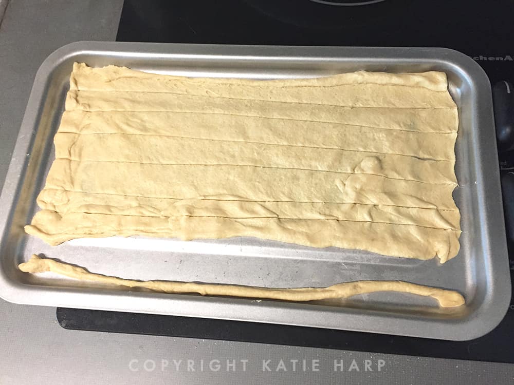 Rolling out the dough onto a sheet pan