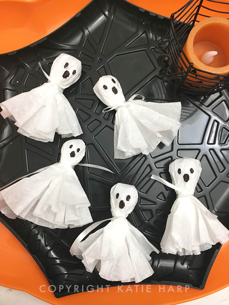 Adding faces to the ghosts with a sharpie marker