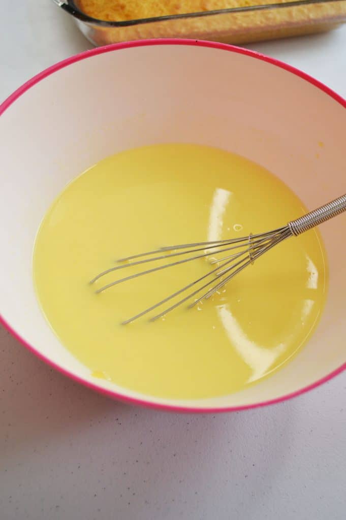 Whisking pudding mix and milk together
