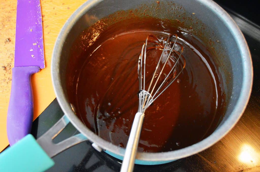 Melting chocolate chips and heavy cream over medium heat