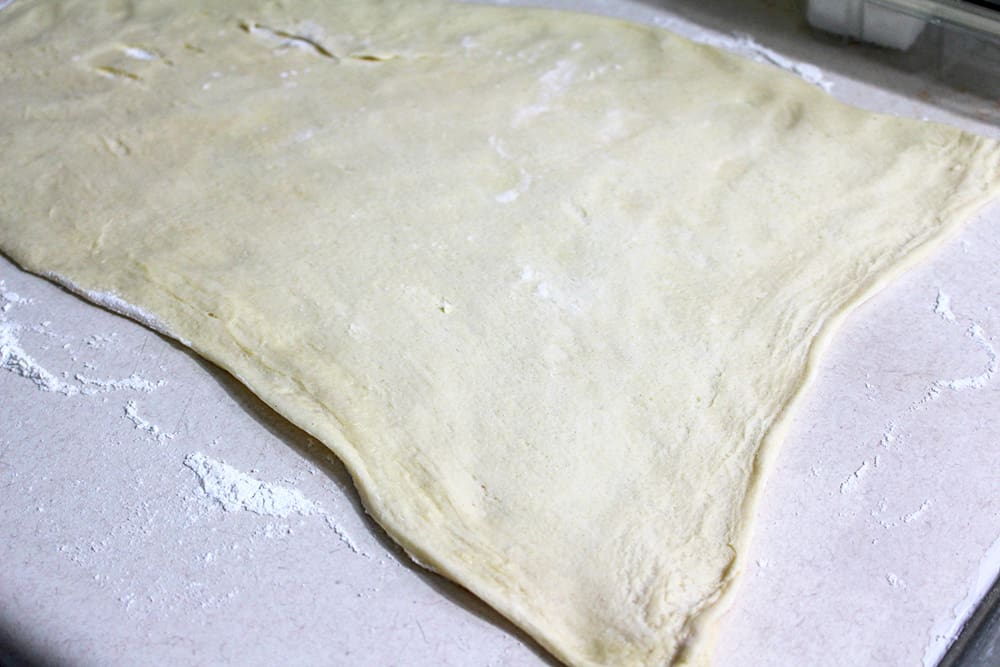 Rolling out a sheet of crescent dough